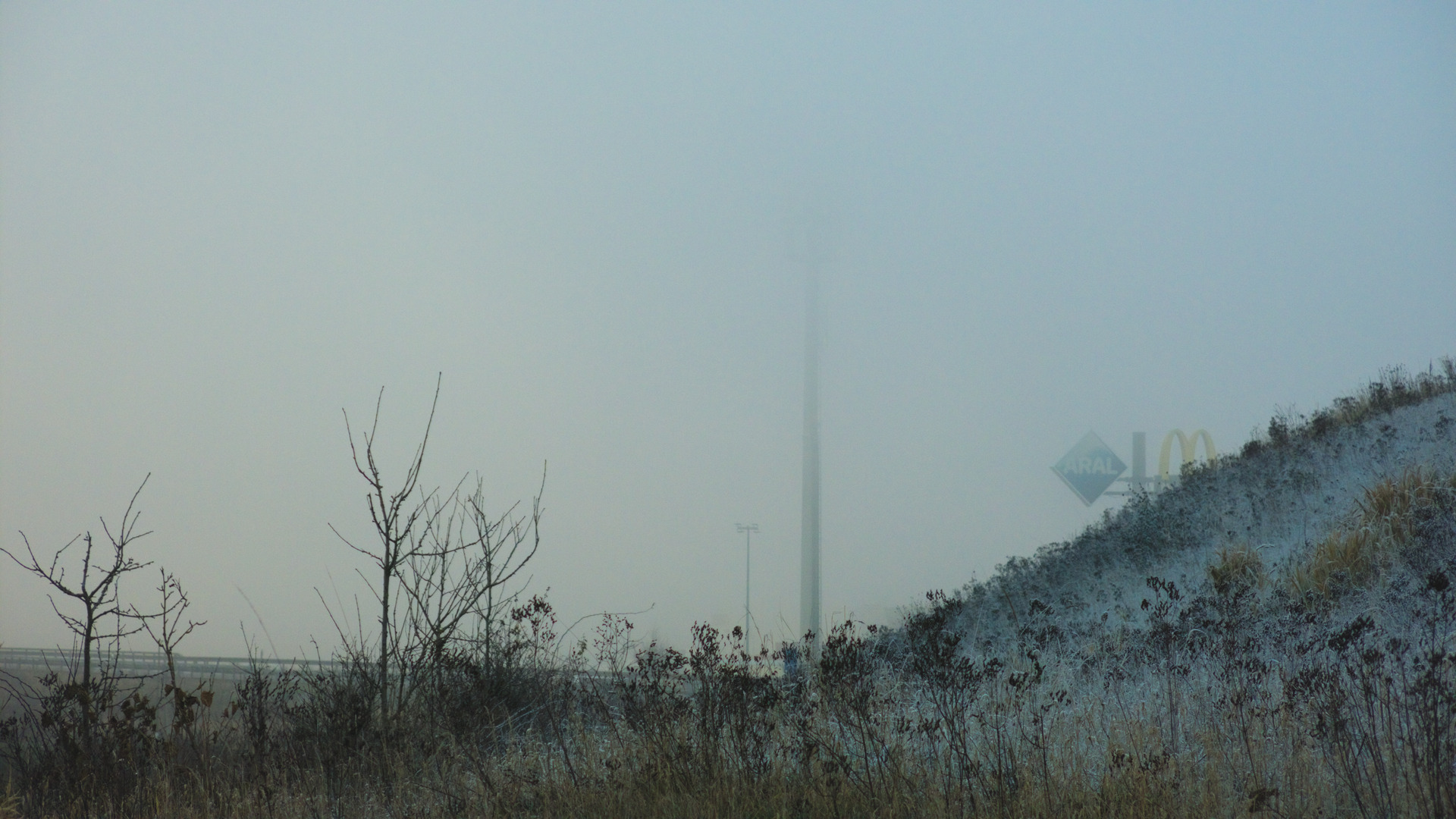 photo of a foggy nowhere but a mcdonalds sign is visible